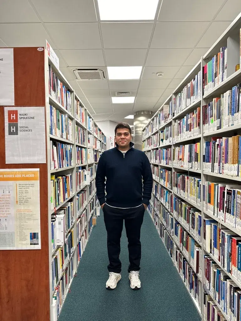 Sherzod Sobitov in a university library